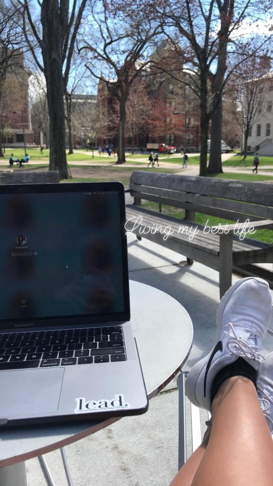 student studying outside with text that reads: 'Living my best life'