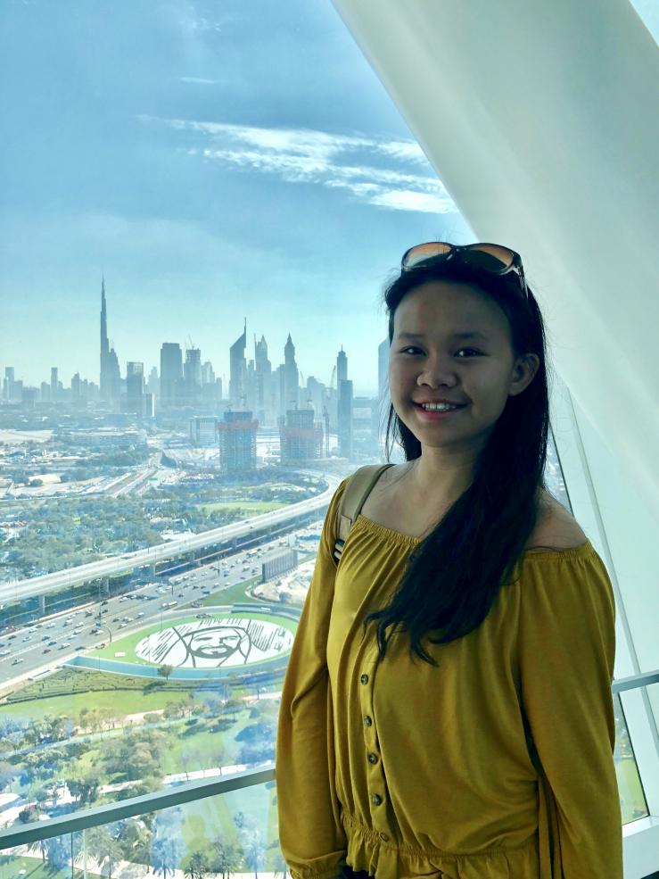 Student with Dubai skyline in the background