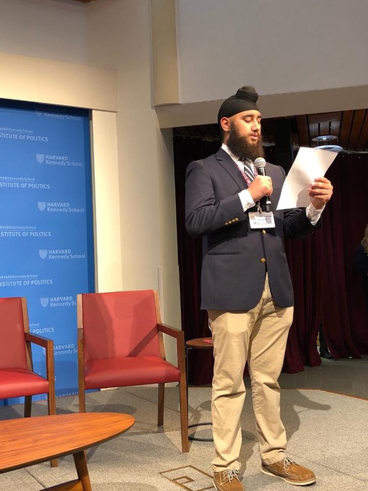 a student on stage at Harvard&#039;s JFK Jr. Forum