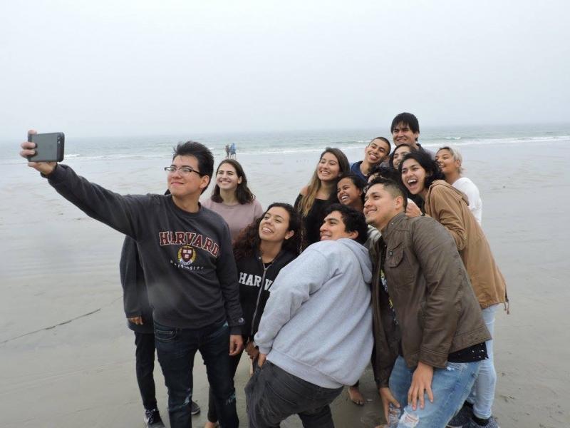 Members of Act on a Dream posing for a picture on a beach