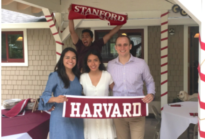 Students holding Harvard flag