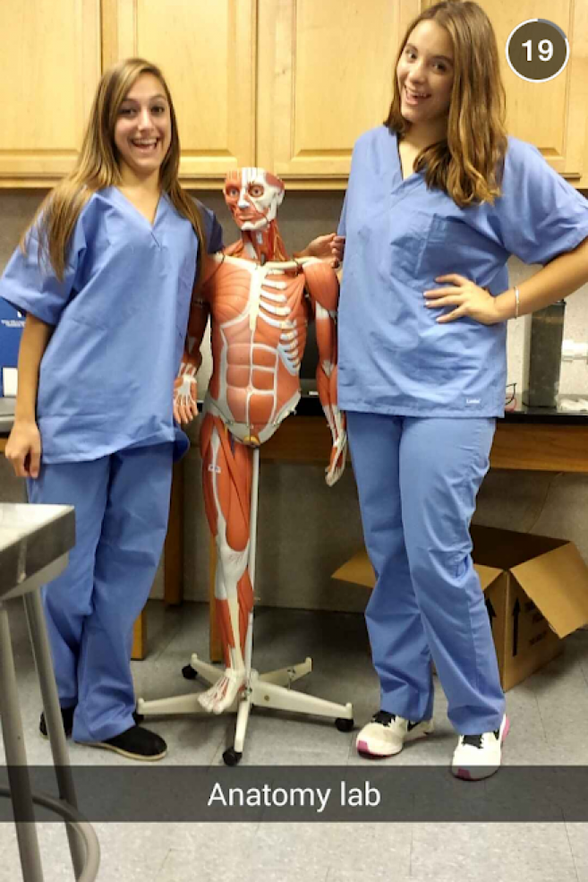 two students with an anatomy model in lab class