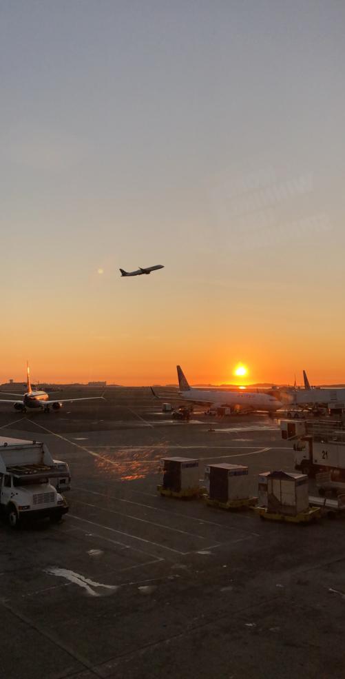 a plane taking off during the sunrise