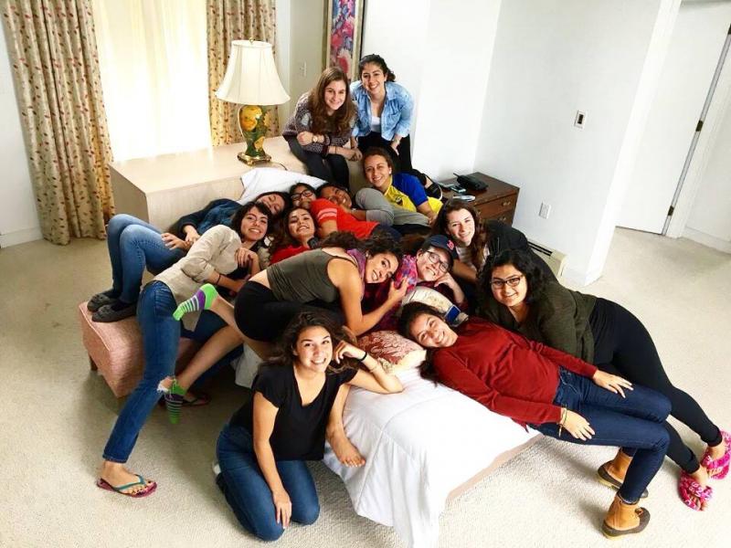 Latinas Unidas board members in 2016 pile on top of one another for a picture