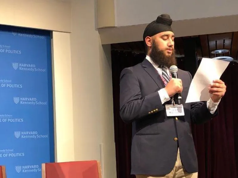 a student on stage at Harvard's JFK Jr. Forum