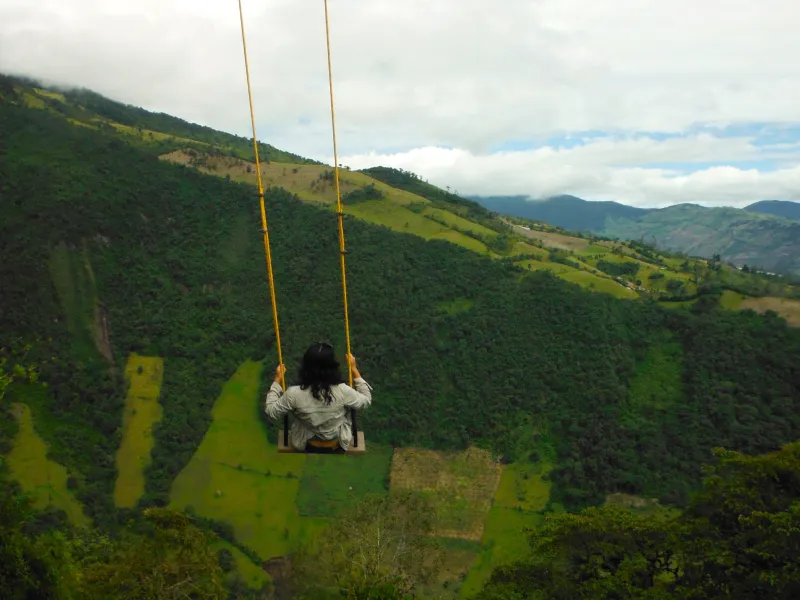 A girl sits on a swing in Ecuador