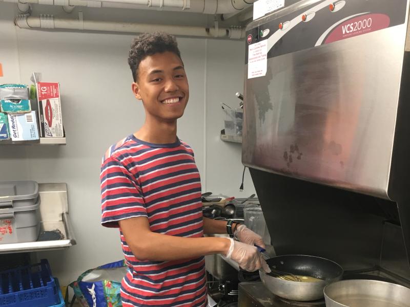 Student cooking in kitchen