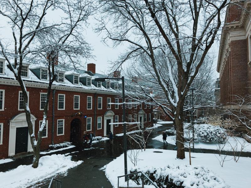 Snow falling outside brick dorm building