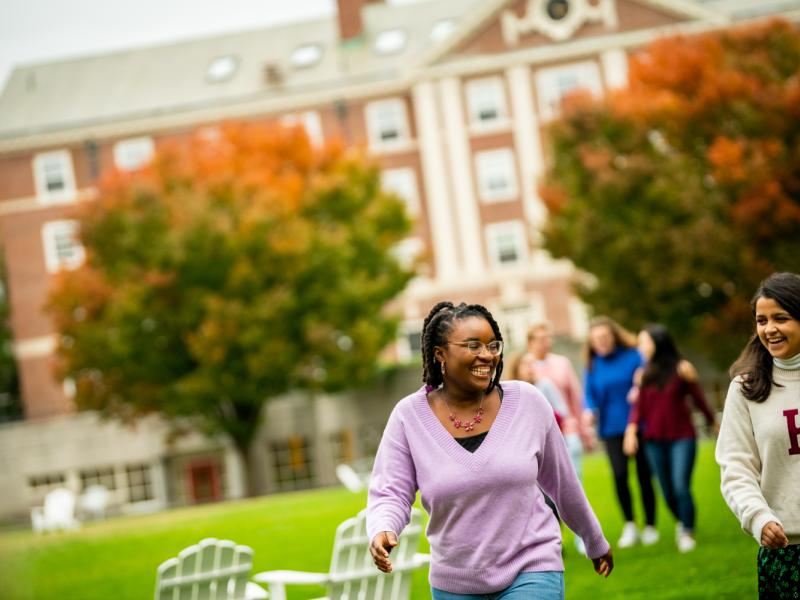 Two female students walking through the Radcliffe Quad