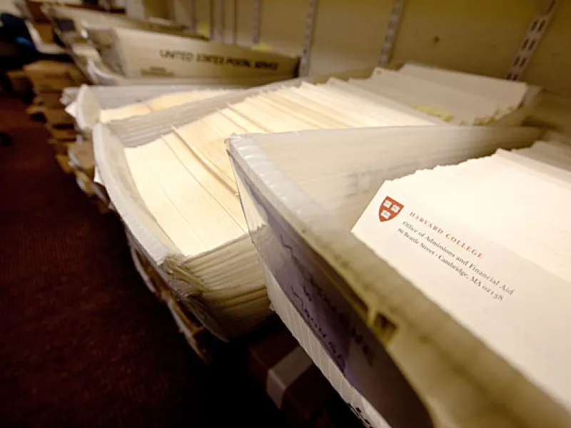 Dozens of admissions packets in mailing bins
