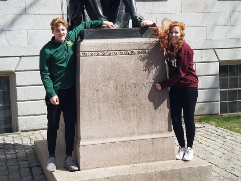 Allison and her brother with the John harvard statue