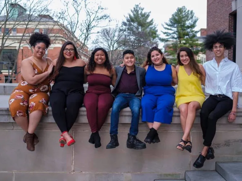 Maribel and friends sit on Widener Library's edge. 
