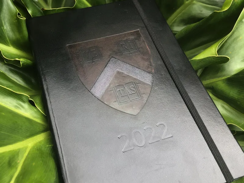 Black journal with Harvard logo and 2022 imprinted on the front