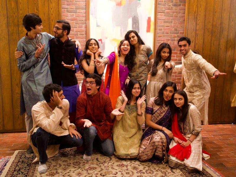 Group of students wearing Indian clothes indoors posing and smiling