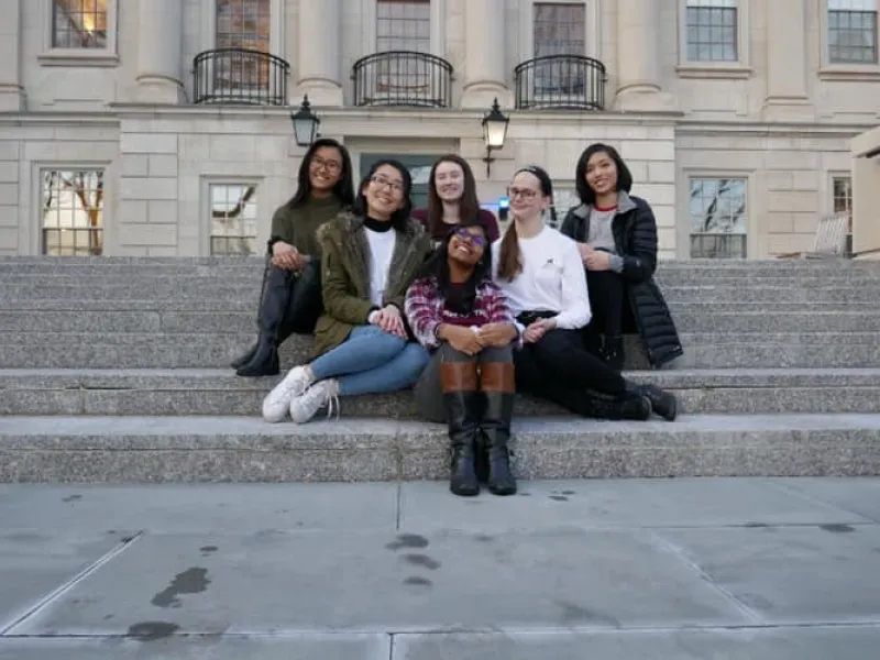 6 ladies sitting on the steps outside of Winthrop House
