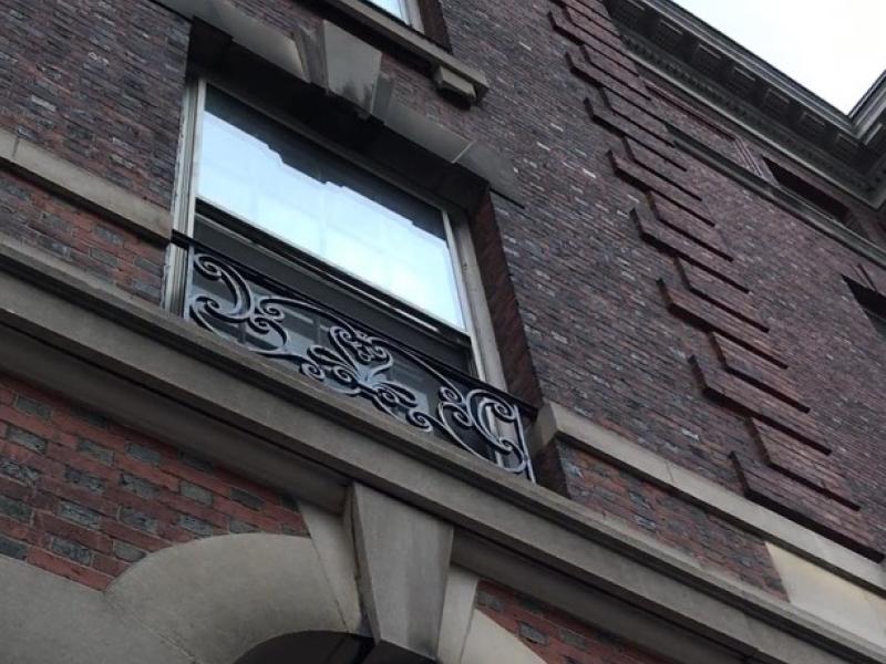 Photo of side of apartment style dorm building with shadows