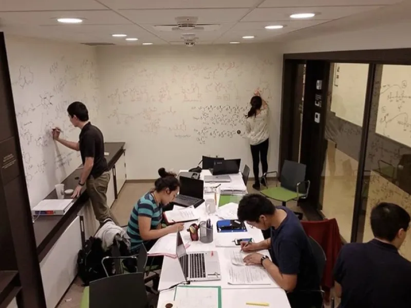 5 students studying in the basement of dorm.
