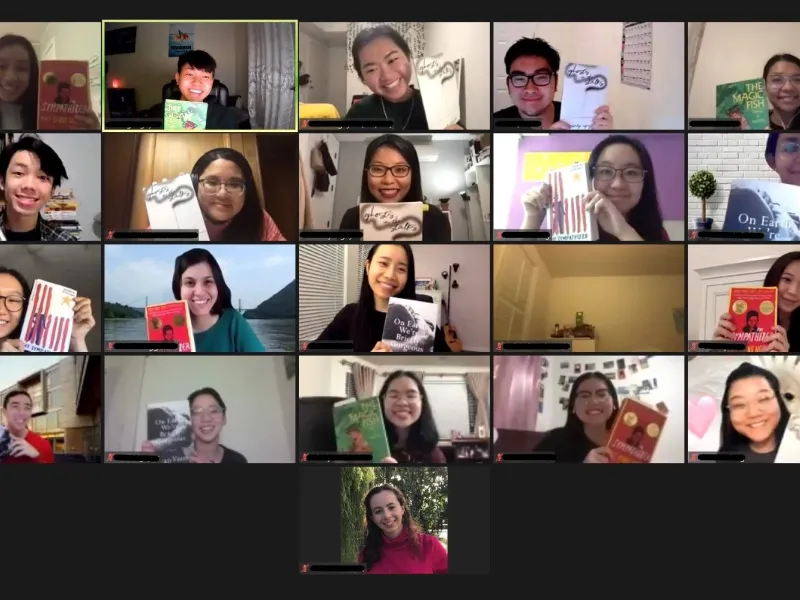 Group of students on Zoom holding up books