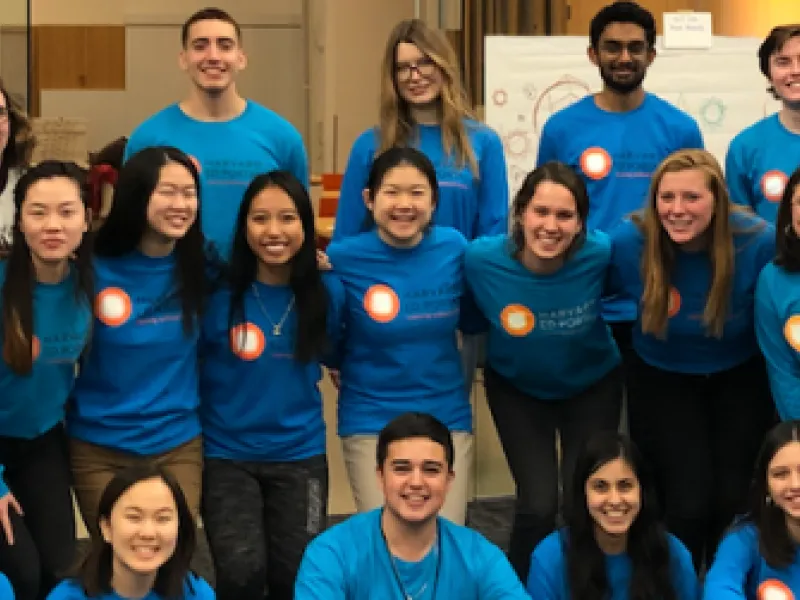 Group of smiling students in blue shirts