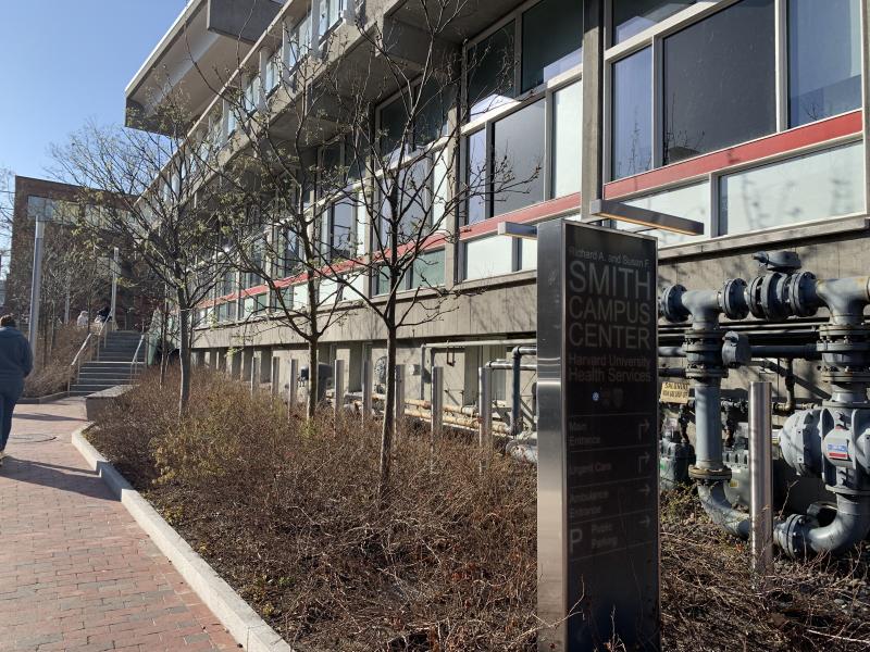 Mt. Auburn Street Side of Harvard University Health Services showing the sidewalk, building and the entrance sign