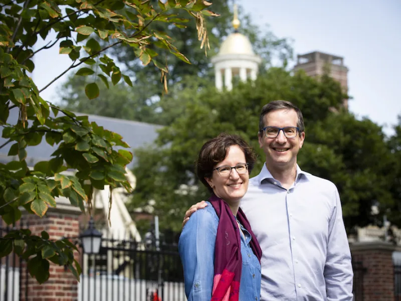 Nina Zipser and David Laibson stand in front of Lowell House