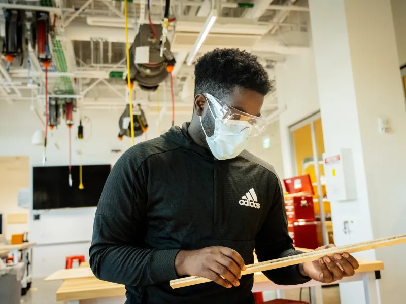 A person looking at a piece of wood