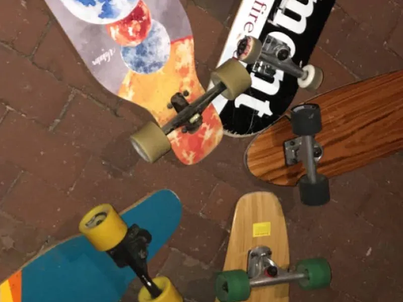 A collection of skateboards all placed near each other.