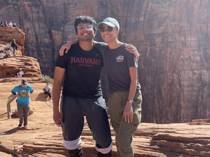 An image of Rafid standing next to FOP director Lesedi Graveline in front of the canyons of Zion National Park, both of them smiling