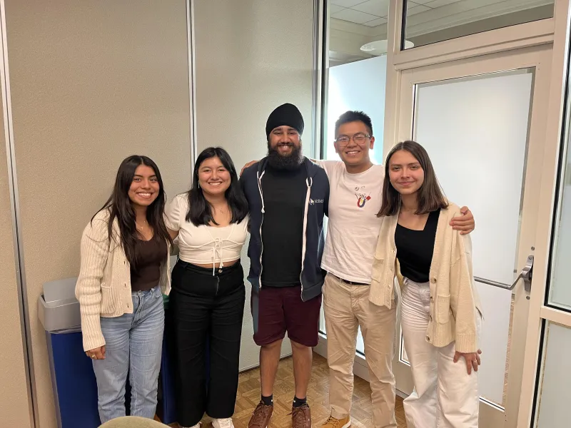 A group of students hugging each other.