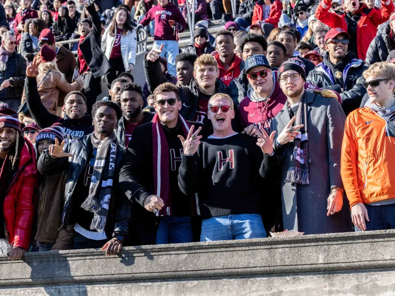 Large crowd of students cheering in the stadium seats