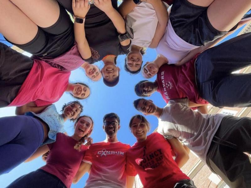 A group of runners looking down at a camera.