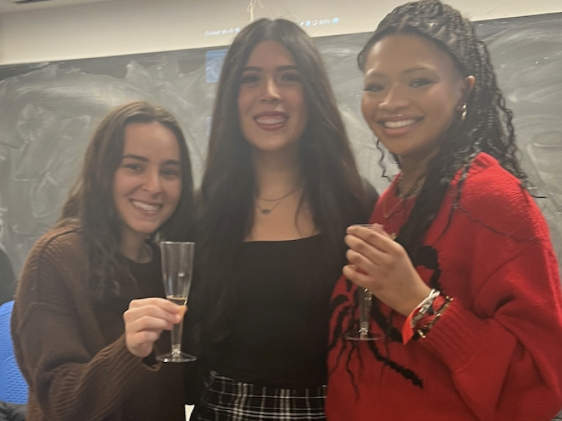 Three girls smiling for a picture. 