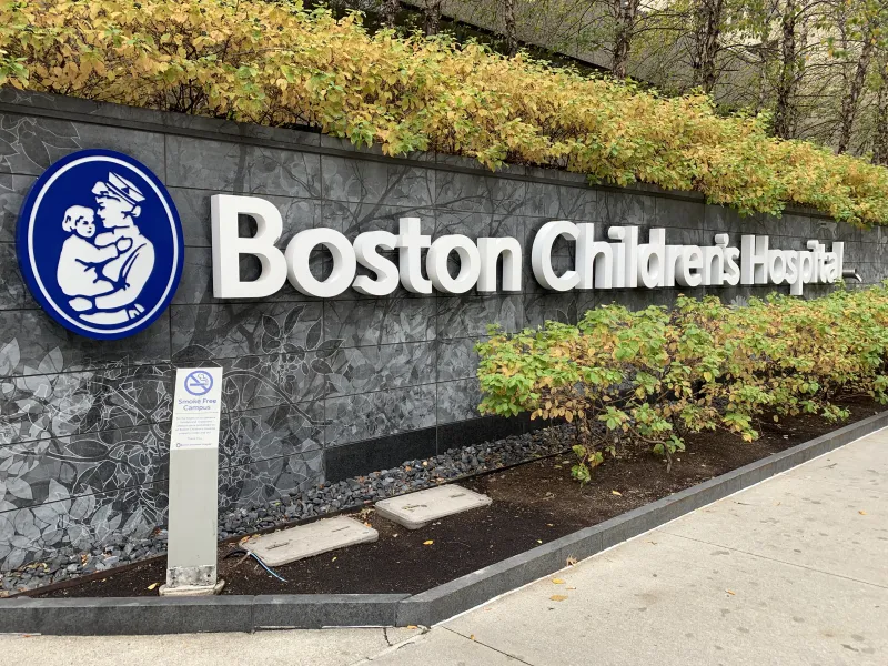 Picture of a Boston Children's Hospital sign placed across a stone wall.