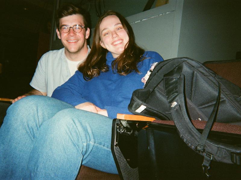 Photo of two people sitting in an auditorium