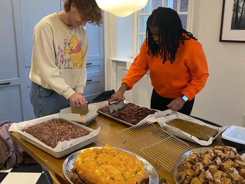 My coworker and I cutting treats to be served at Lowell Tea.