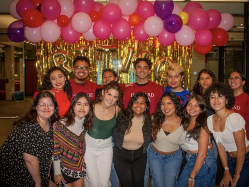 Fuerza Latina Board Posing In Front of a Ritmo Latino Sign