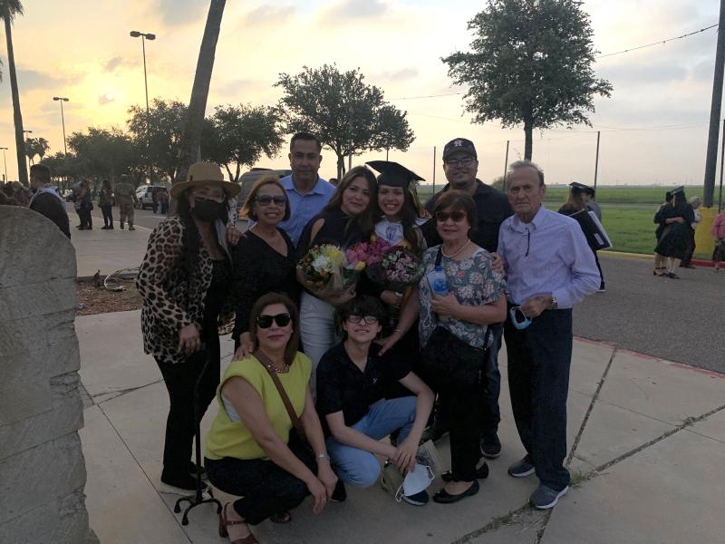 Ana with her family member at her high school graduation.