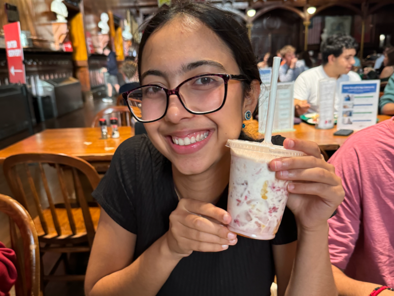 Meena holding up her created drink at Berg