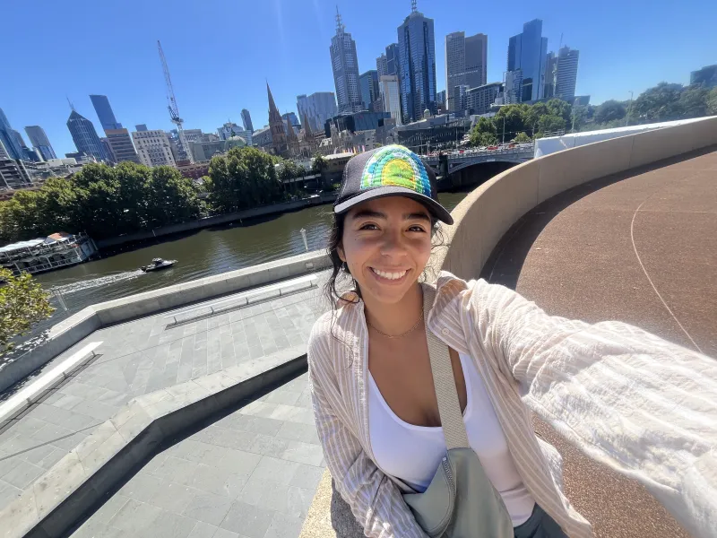 A smiling selfie on a sunny day with the Melbourne city skyline in the back
