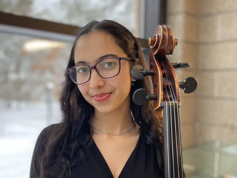The author with her cello standing.
