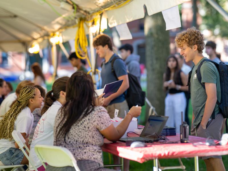 A student from the Class of 2029 checks in at the registration table during move-in day.