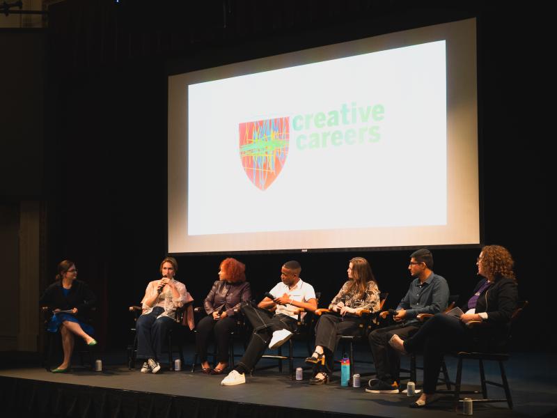 Panelists sit on stage under a screen displaying "creative careers."