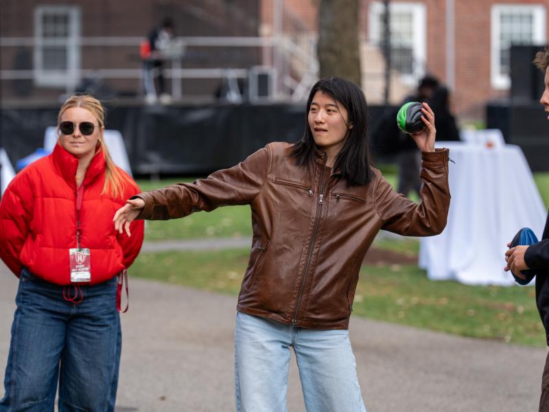 A family student aims to throw the ball during the football toss.