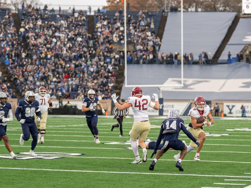 Harvard makes a running play with the ball during the game.