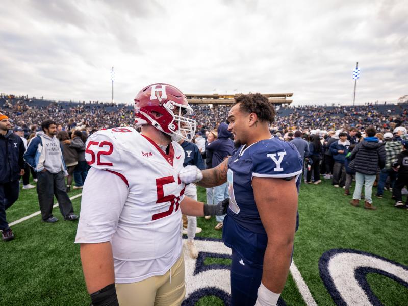 A Harvard football player and Yale football player speak to each other after the game.