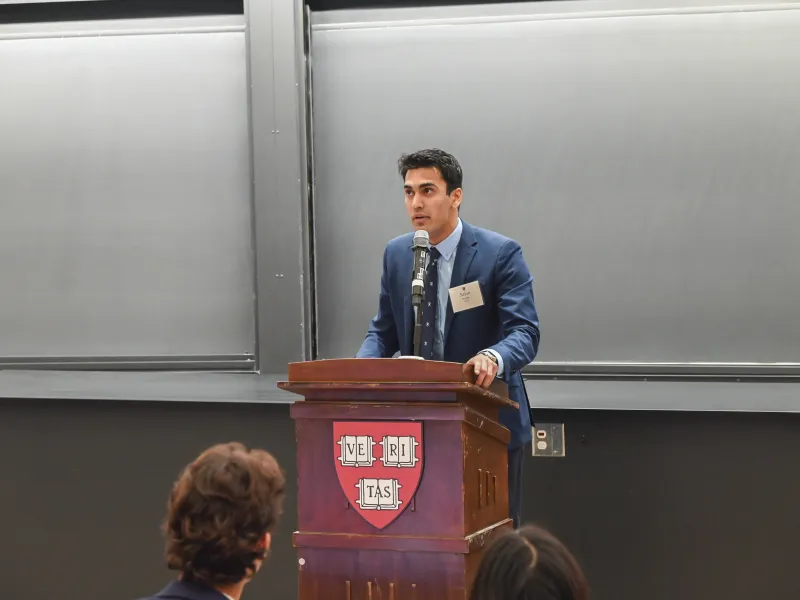 Student speaker Arjun Purohit ’25 standing at the podium delivering his speech.
