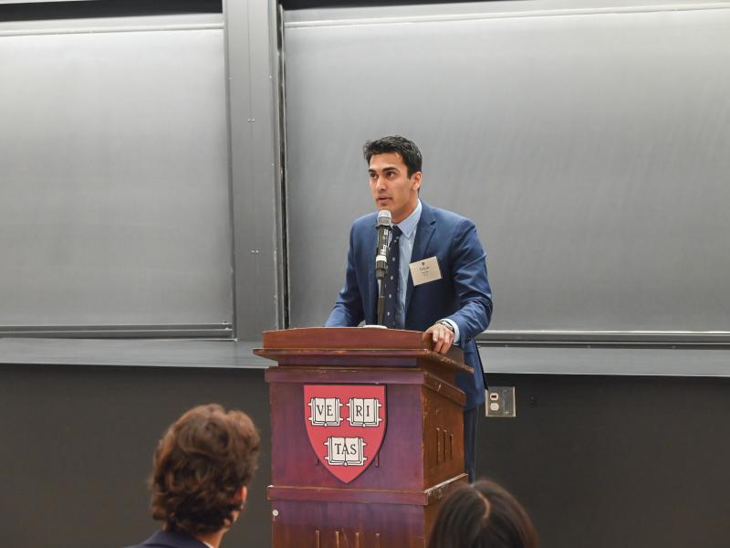 Student speaker Arjun Purohit ’25 standing at the podium delivering his speech.