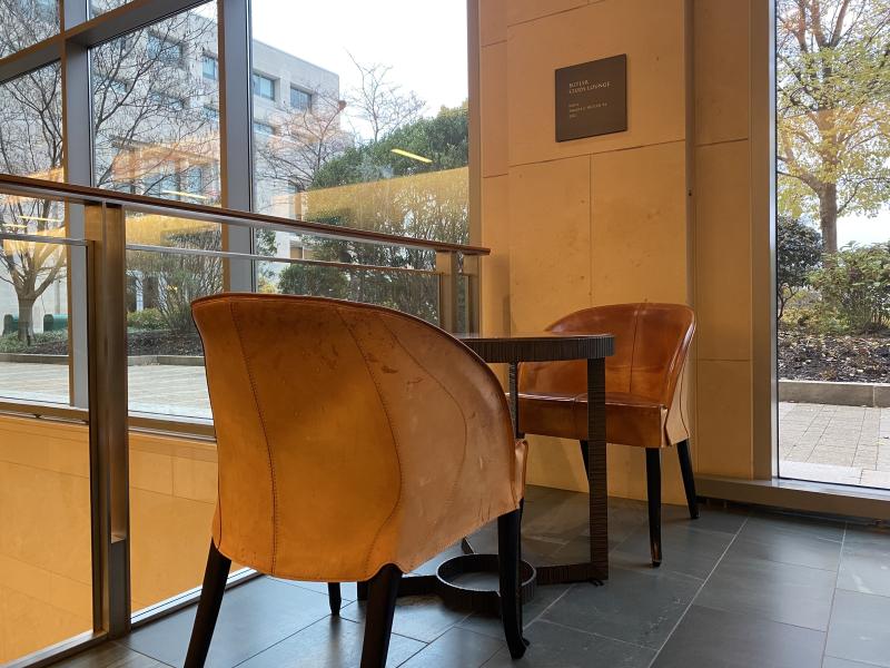 Two golden chairs seated across from each other with a table in between.