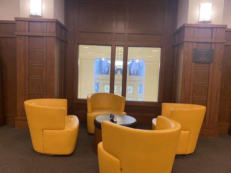 Four orange chairs arranged in a circle.