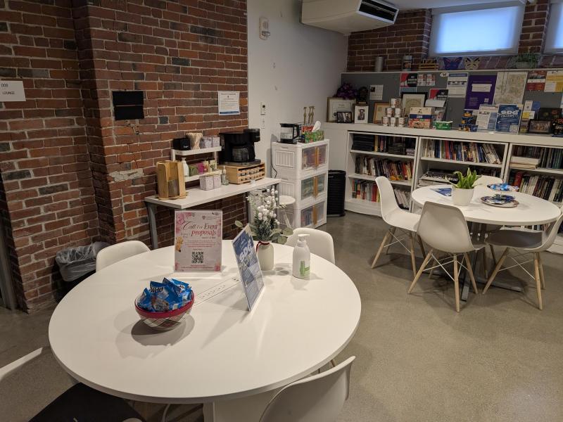 Two white round tables and chairs.